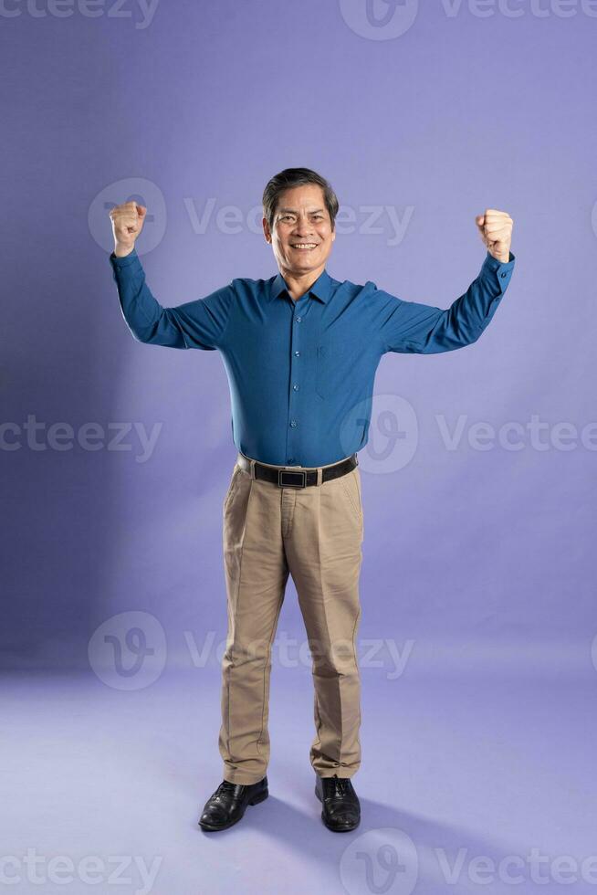 ritratto di mezzo anziano asiatico attività commerciale uomo in posa su viola sfondo foto