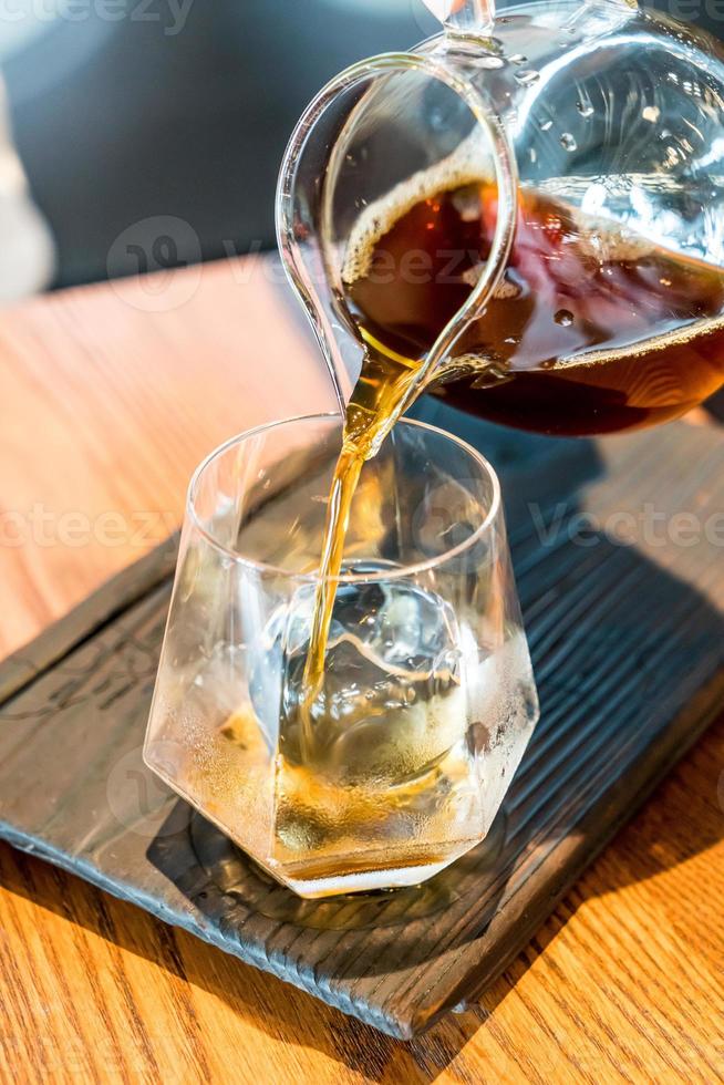 barattolo di caffè nero a goccia fredda con vetro e ghiaccio nella caffetteria e nel ristorante foto