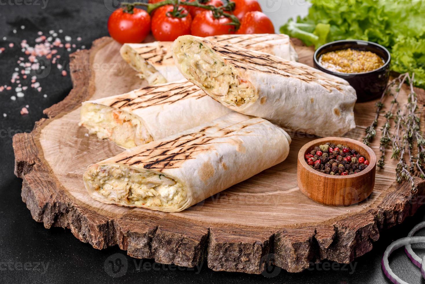 delizioso shawarma fresco con carne e verdure su un tavolo di cemento scuro foto