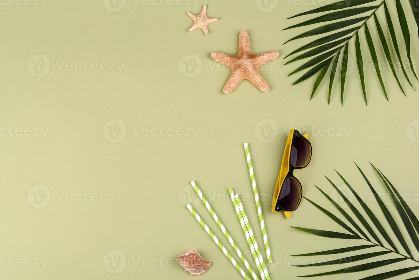 accessori da spiaggia, occhiali e cappello con conchiglie e stelle marine su sfondo colorato foto