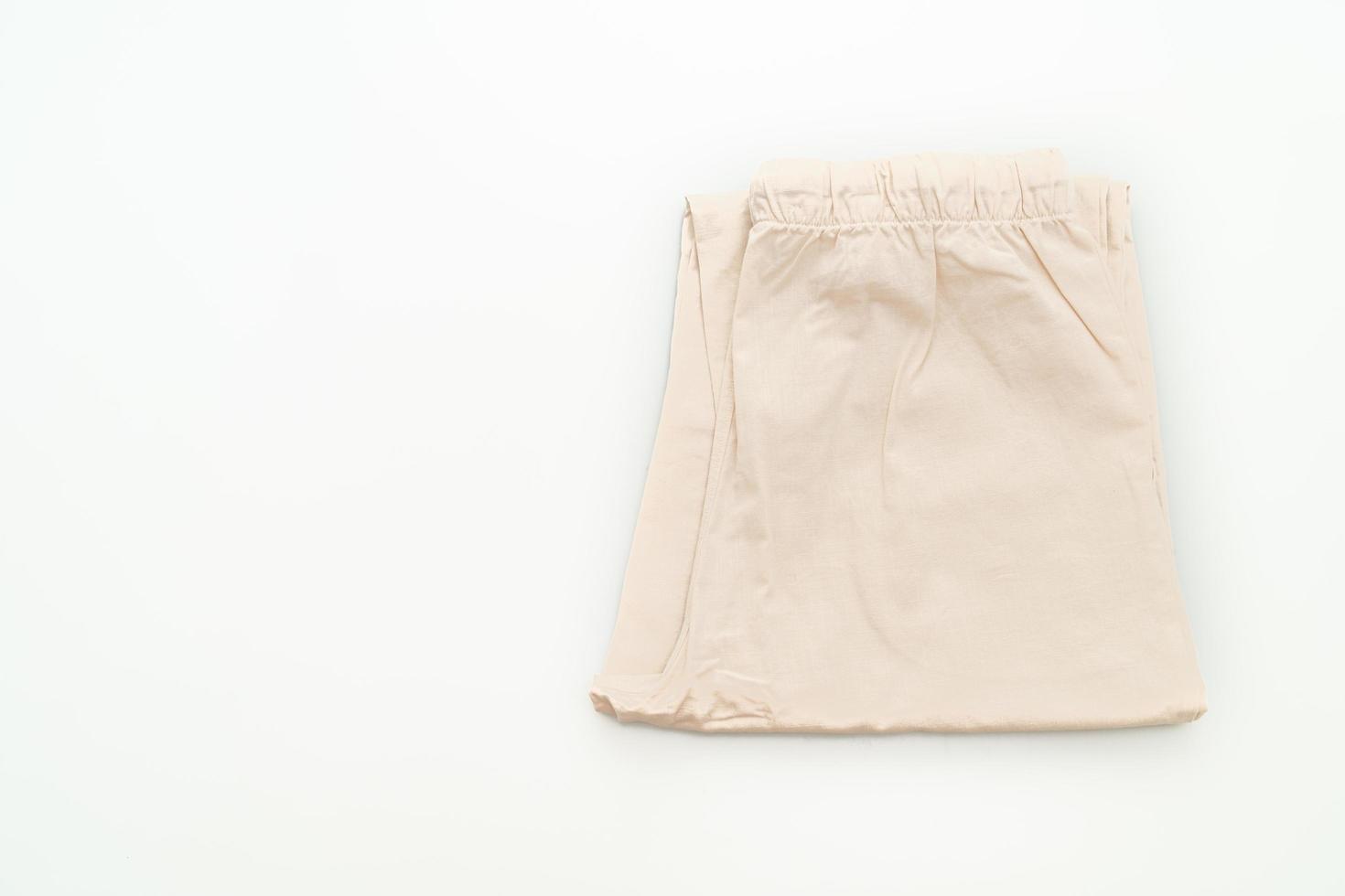 pantalone beige piegato isolato su sfondo bianco foto