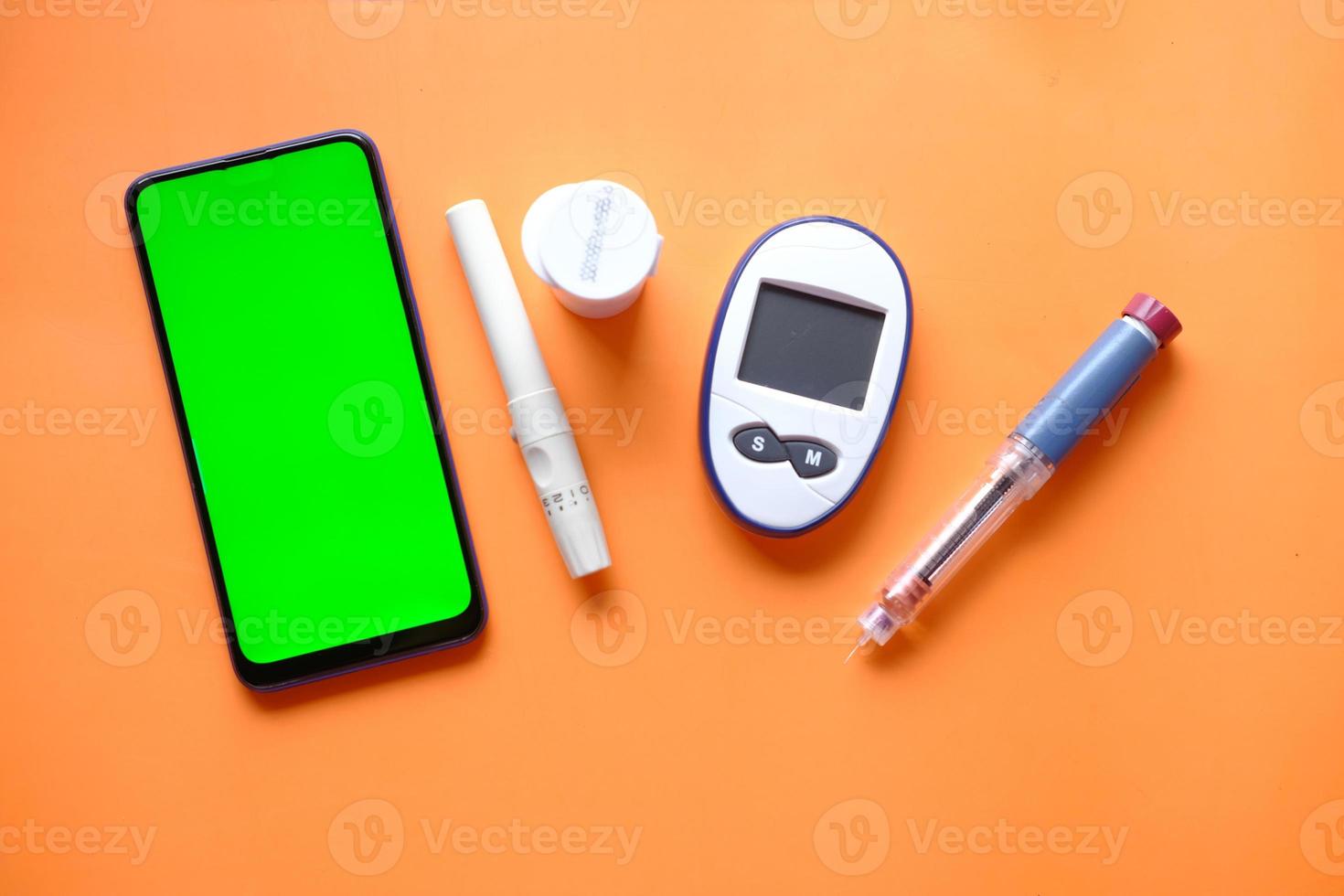 penna per insulina, strumenti di misurazione del diabete e uno smartphone con foto