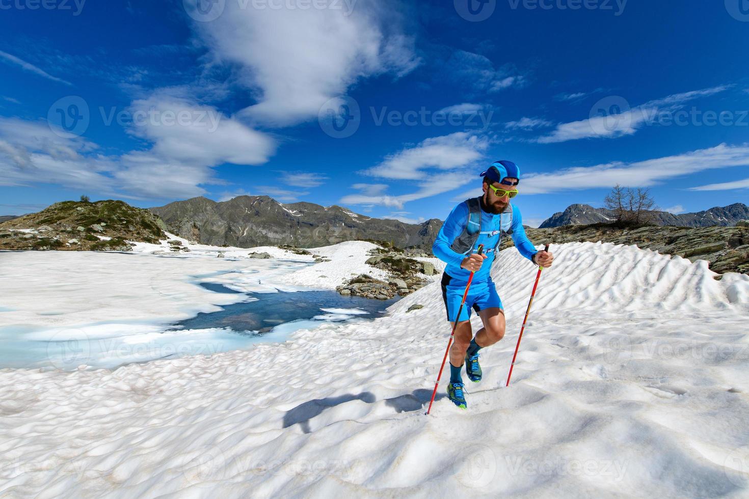 skyrunner uomo in salita in un tratto innevato foto