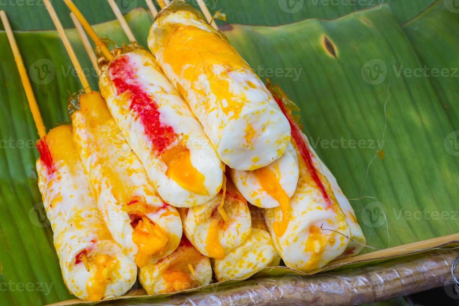 Rotolo di frittata stick su foglia di banana nel mercato tailandese foto