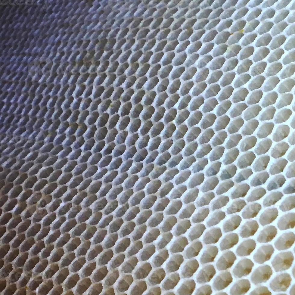 la struttura esagonale è a nido d'ape dall'alveare pieno di miele dorato foto