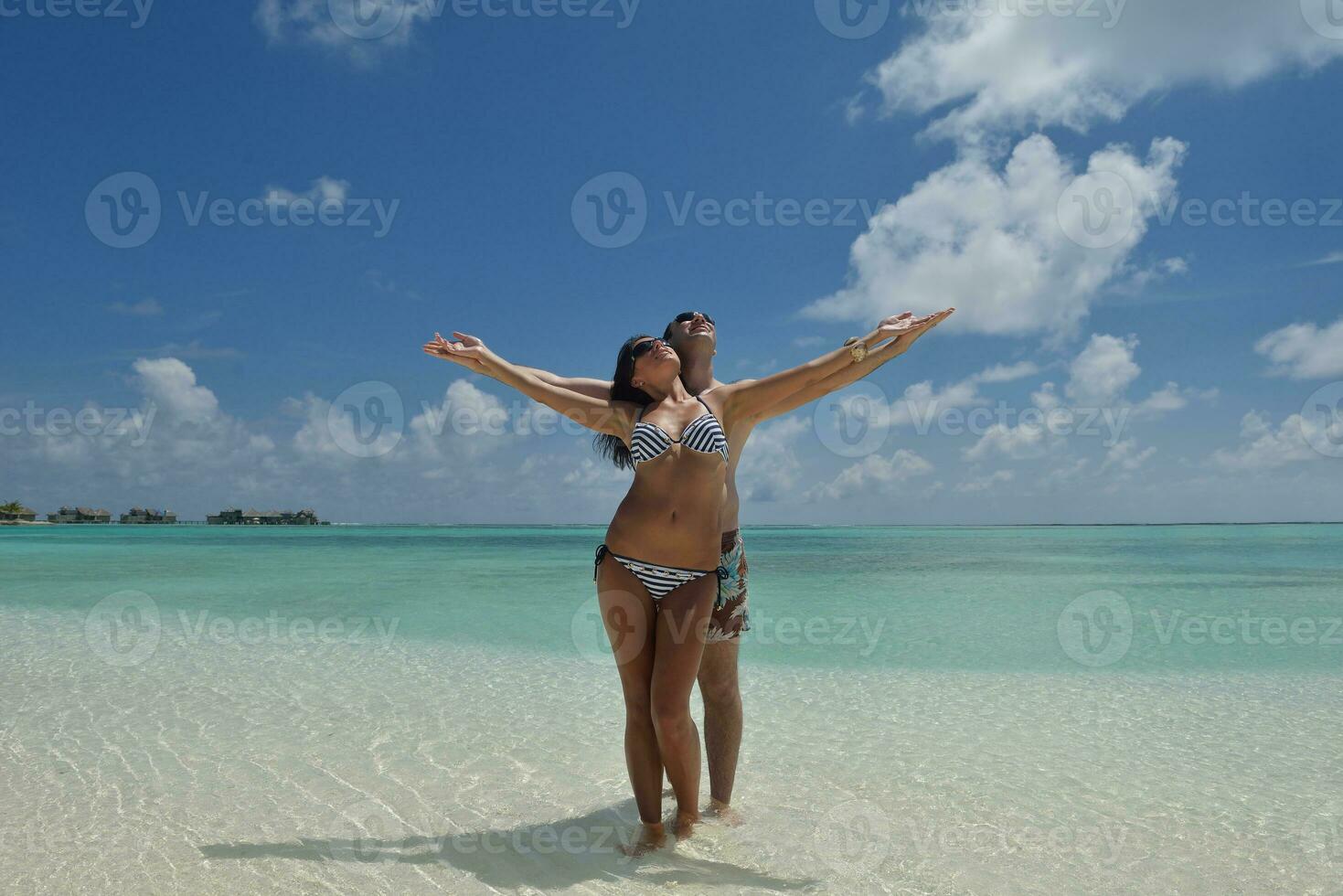 la giovane coppia felice si diverte sulla spiaggia foto