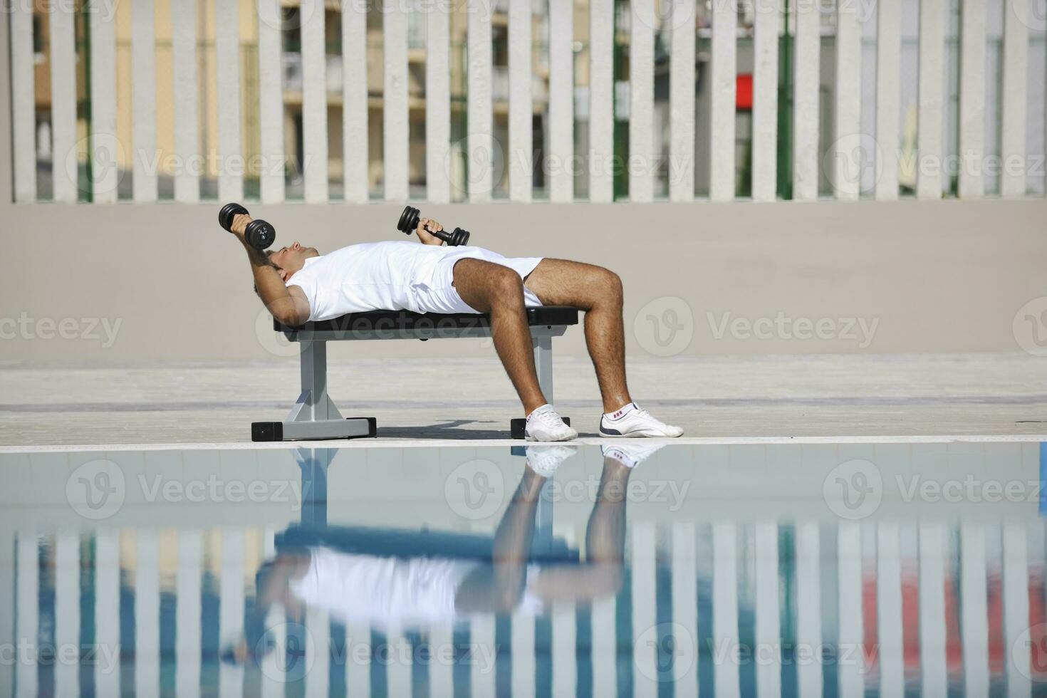 giovane uomo esercizio a bordo piscina foto