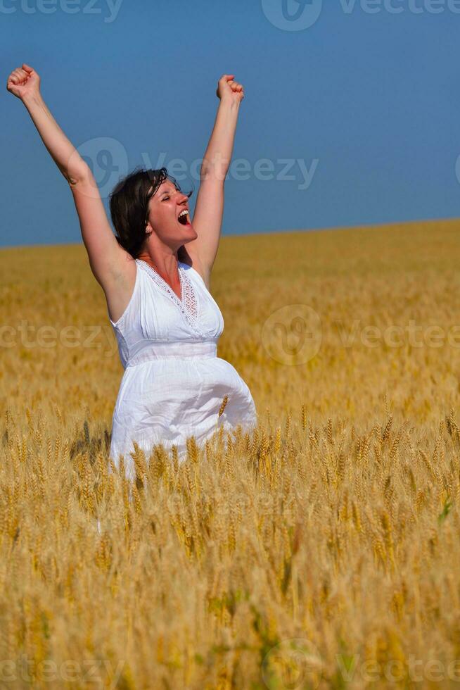 giovane donna nel campo di grano in estate foto