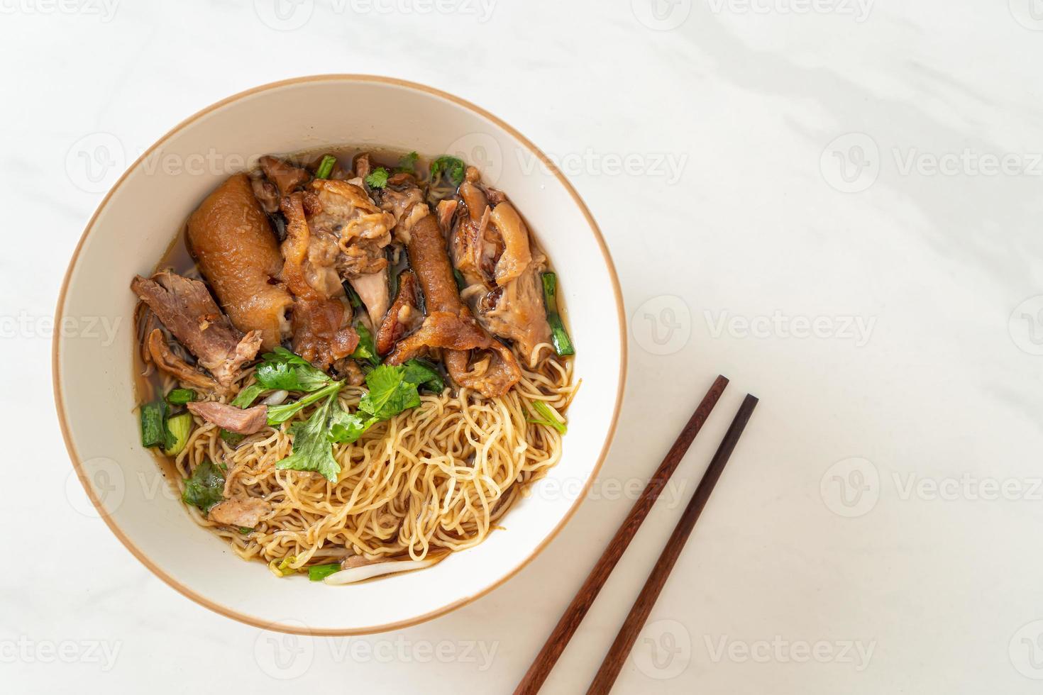 noodles di coscia di maiale in umido in zuppa marrone foto