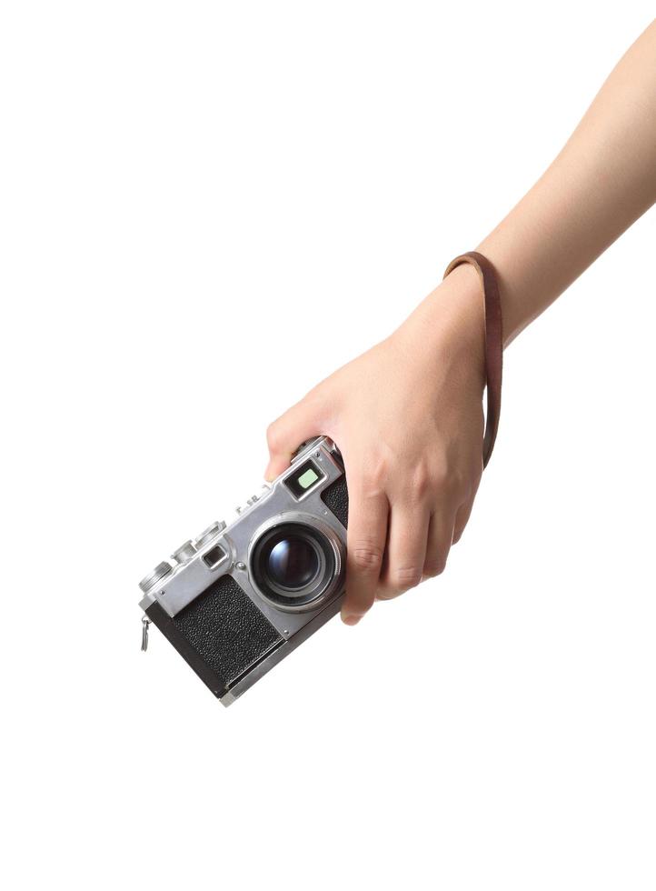 mano che tiene la macchina fotografica d'epoca su sfondo bianco foto