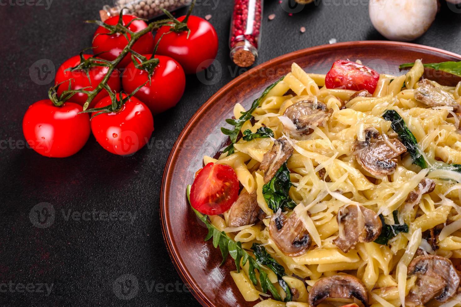 pasta con funghi, formaggio, spinaci, rukkola e pomodorini foto