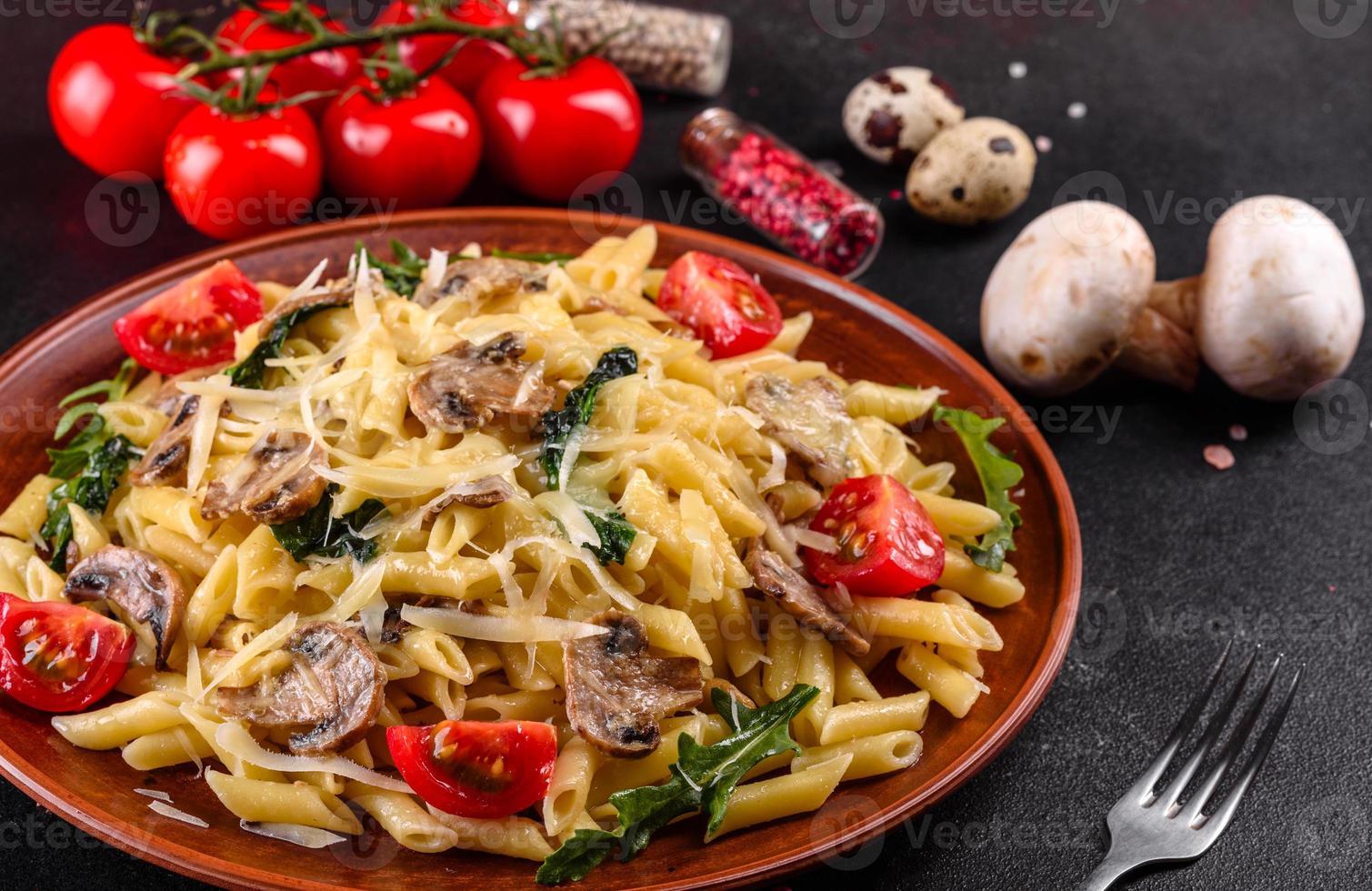 pasta con funghi, formaggio, spinaci, rukkola e pomodorini foto