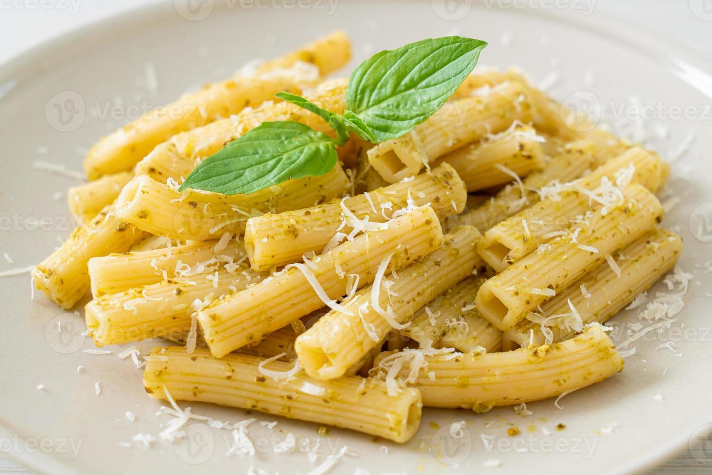 rigatoni al pesto con parmigiano - cibo italiano e stile vegetariano foto