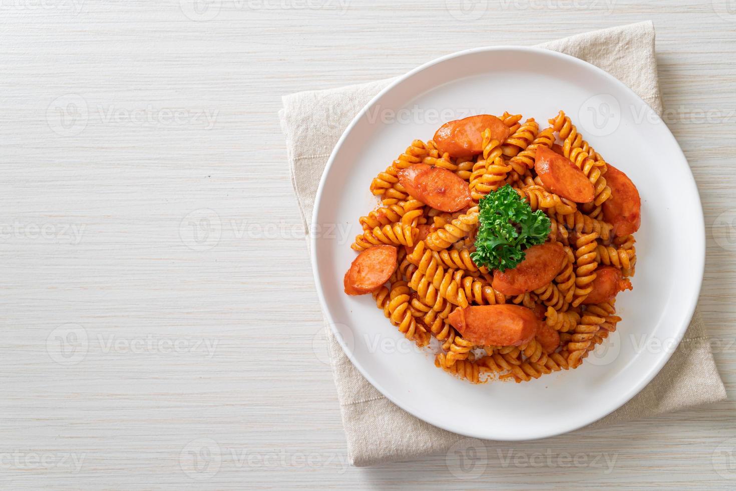 pasta a spirale o spirali con salsa di pomodoro e salsiccia - stile italiano foto