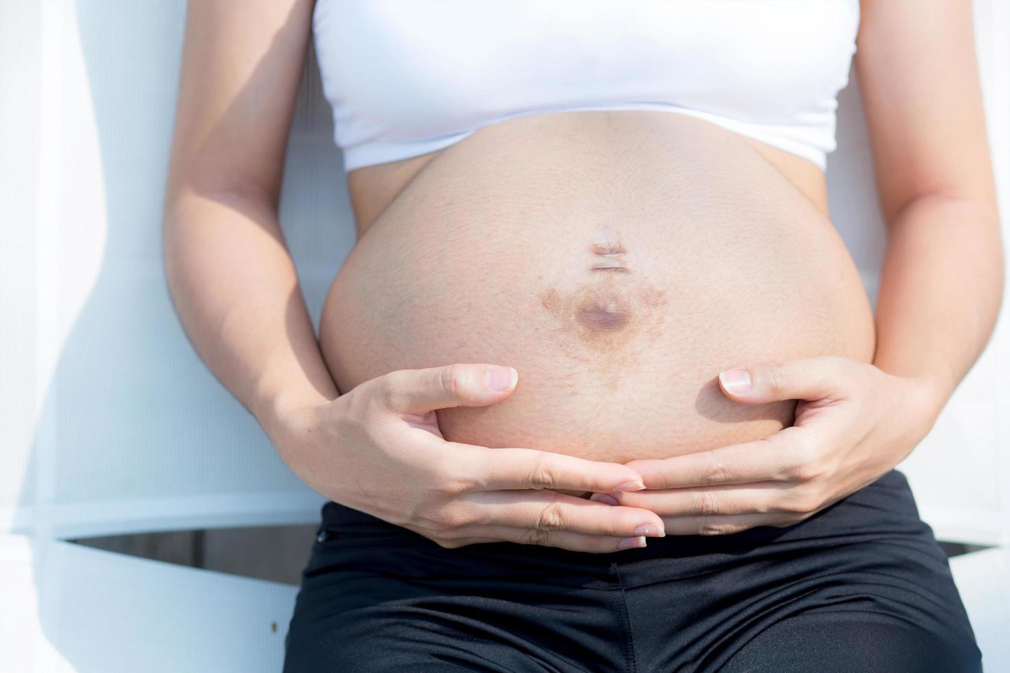 primo piano mano di donna incinta foto