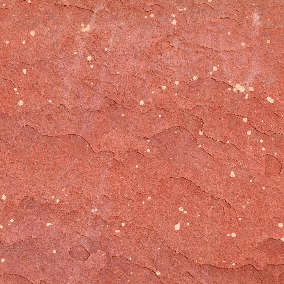 fondo di struttura di pietra grezza rossa. foto
