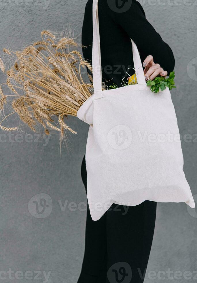 giovane ragazza Tenere un' stoffa Borsa con orecchie di Grano foto