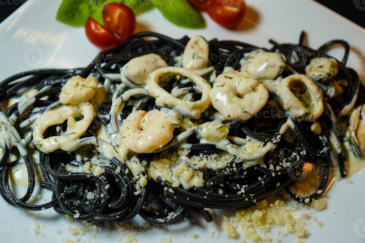 spaghetti rigate - pasta nera con frutti di mare misti foto