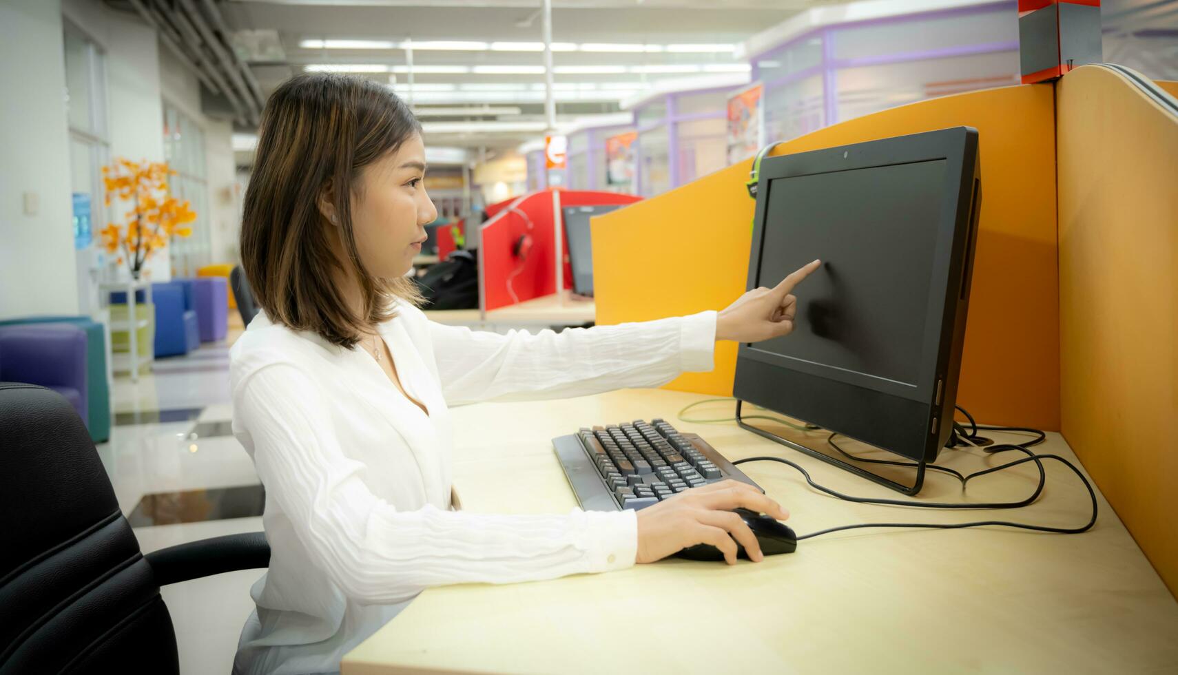 bellissimo asiatico ufficio ragazza inding opera insetto su computer nel aziendale ufficio. foto