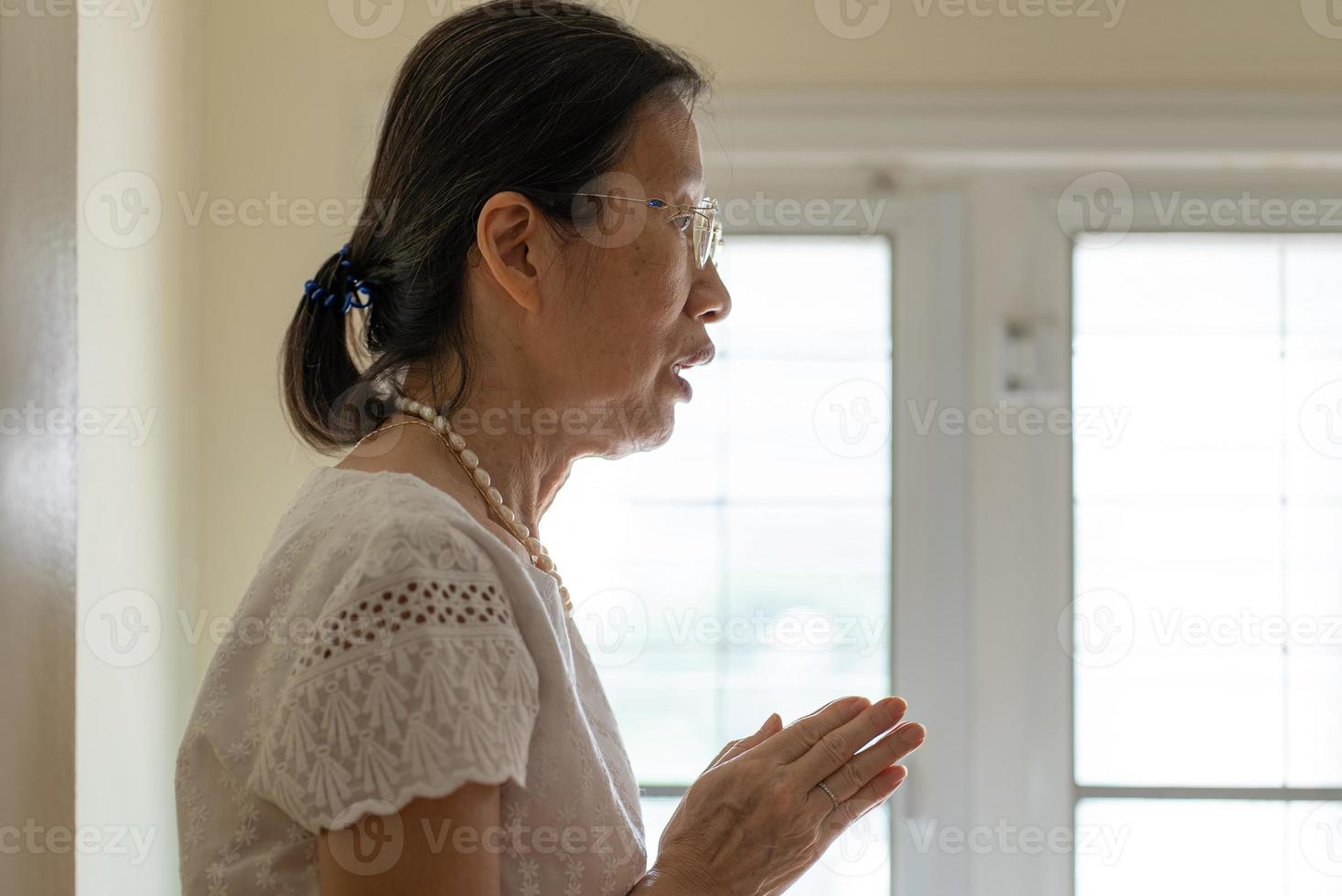 donna anziana che fa meditazione a casa. concetto di consapevolezza foto