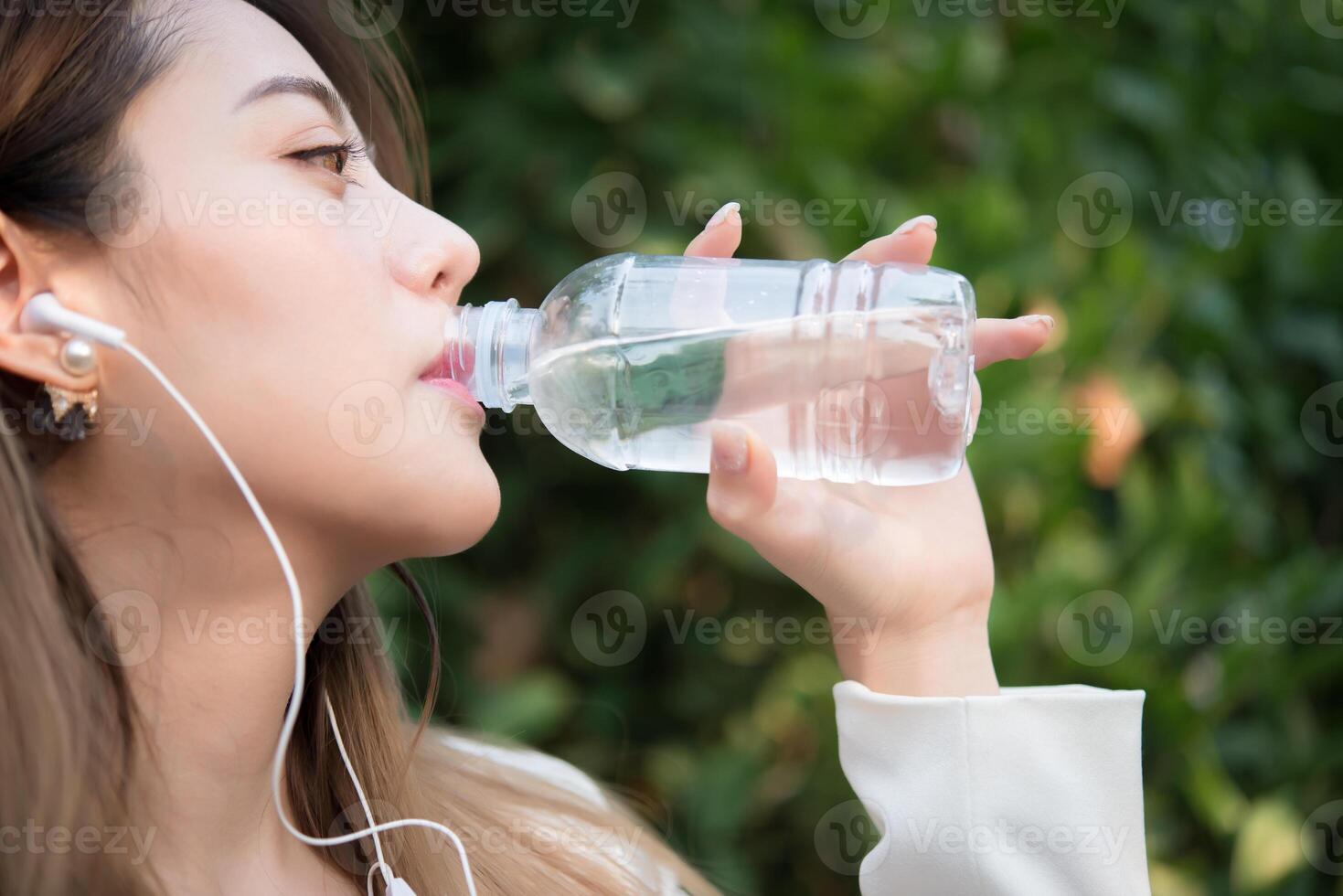 bella donna d'affari che beve acqua dopo un duro lavoro foto