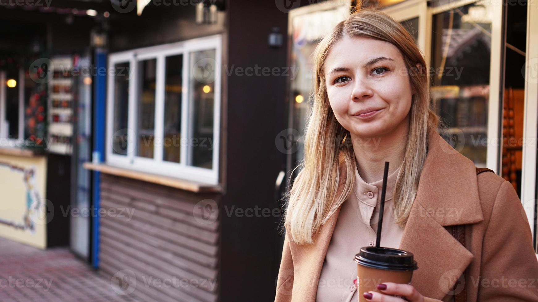 giovane bionda con una tazza di caffè. donna alla food court foto