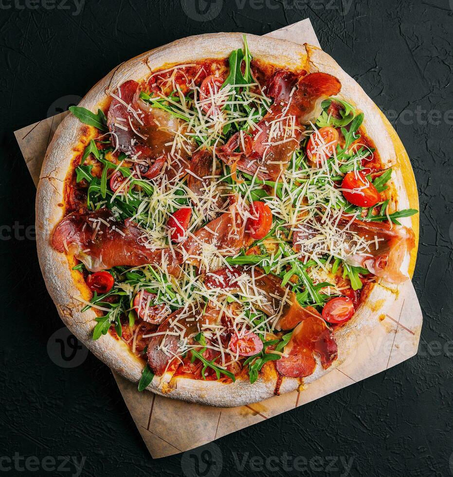 italiano Pizza con prosciutto, rucola e pomodori foto