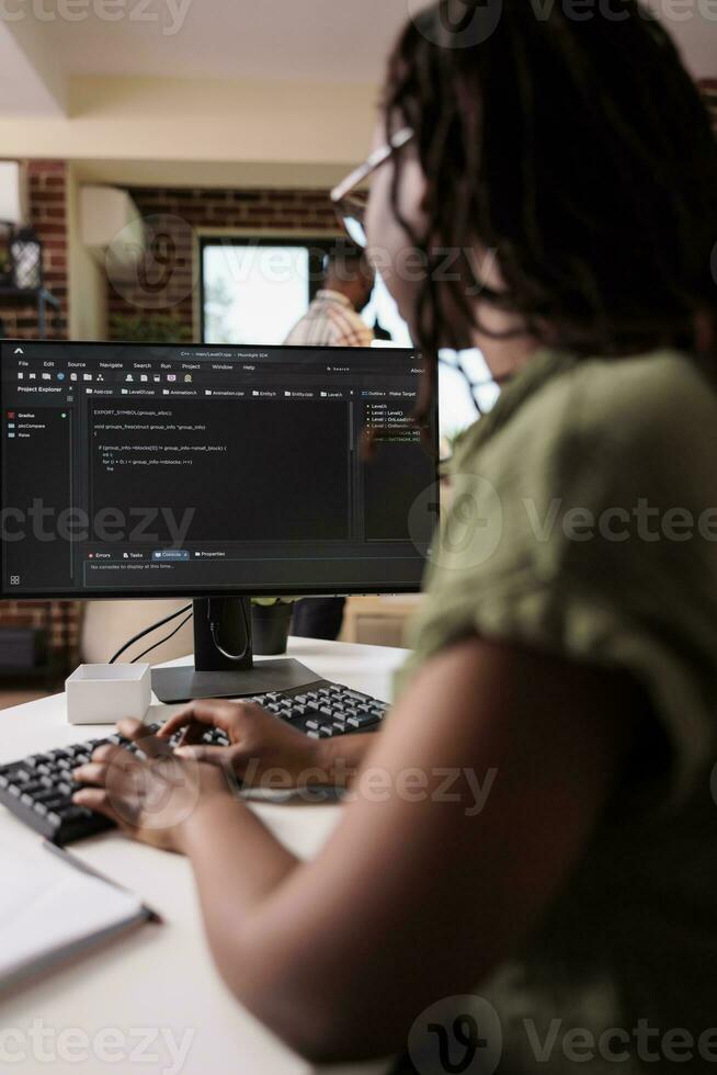 africano americano alunno apprendimento programmazione scrittura fonte codice mentre fidanzato è rilassante nel casa vivente camera. libero professionista Software sviluppatore Lavorando a distanza debug algoritmo utilizzando personale foto