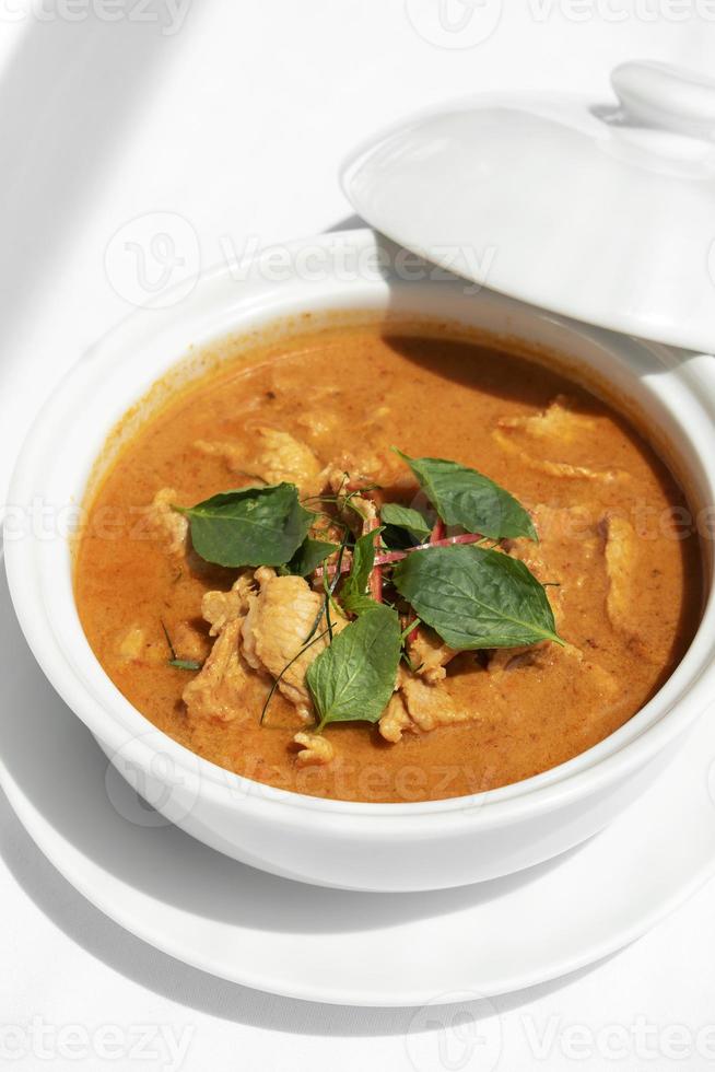 curry di maiale panang piccante tailandese con latte di cocco sulla tavola di legno a phuket thailand foto