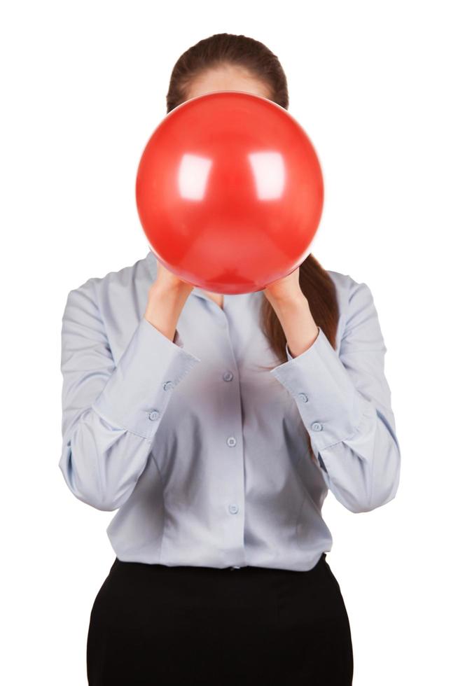 ragazza con una camicia grigia tiene un palloncino gonfiato foto