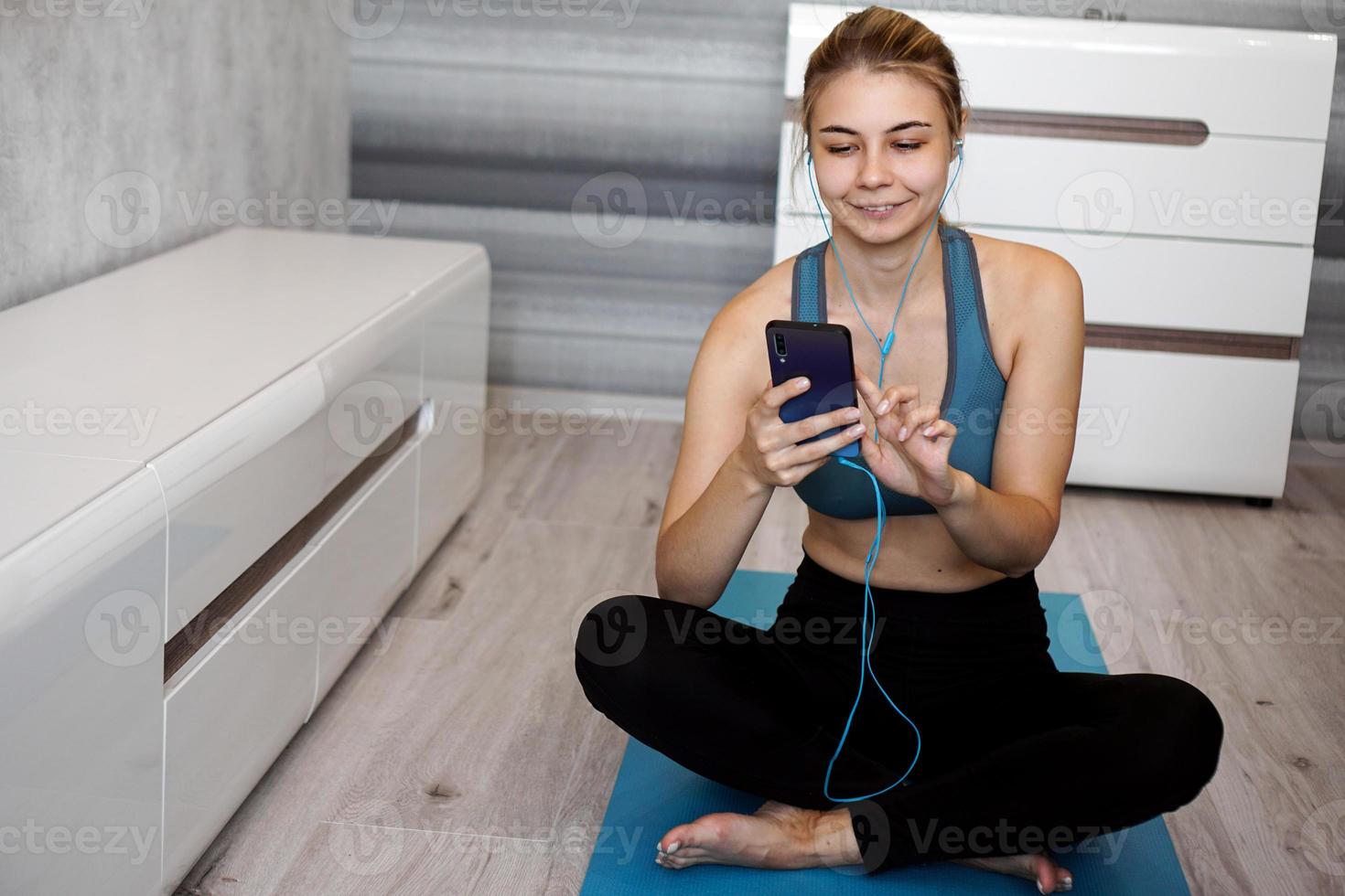 donna sportiva con gli auricolari che si gode la musica che suona foto