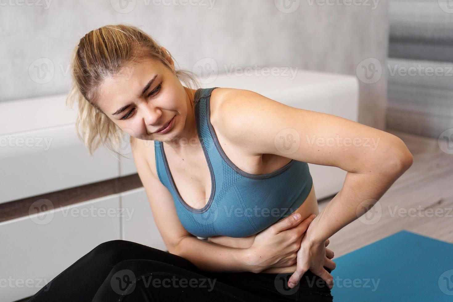 ritratto di giovane donna seduta sul materassino yoga foto