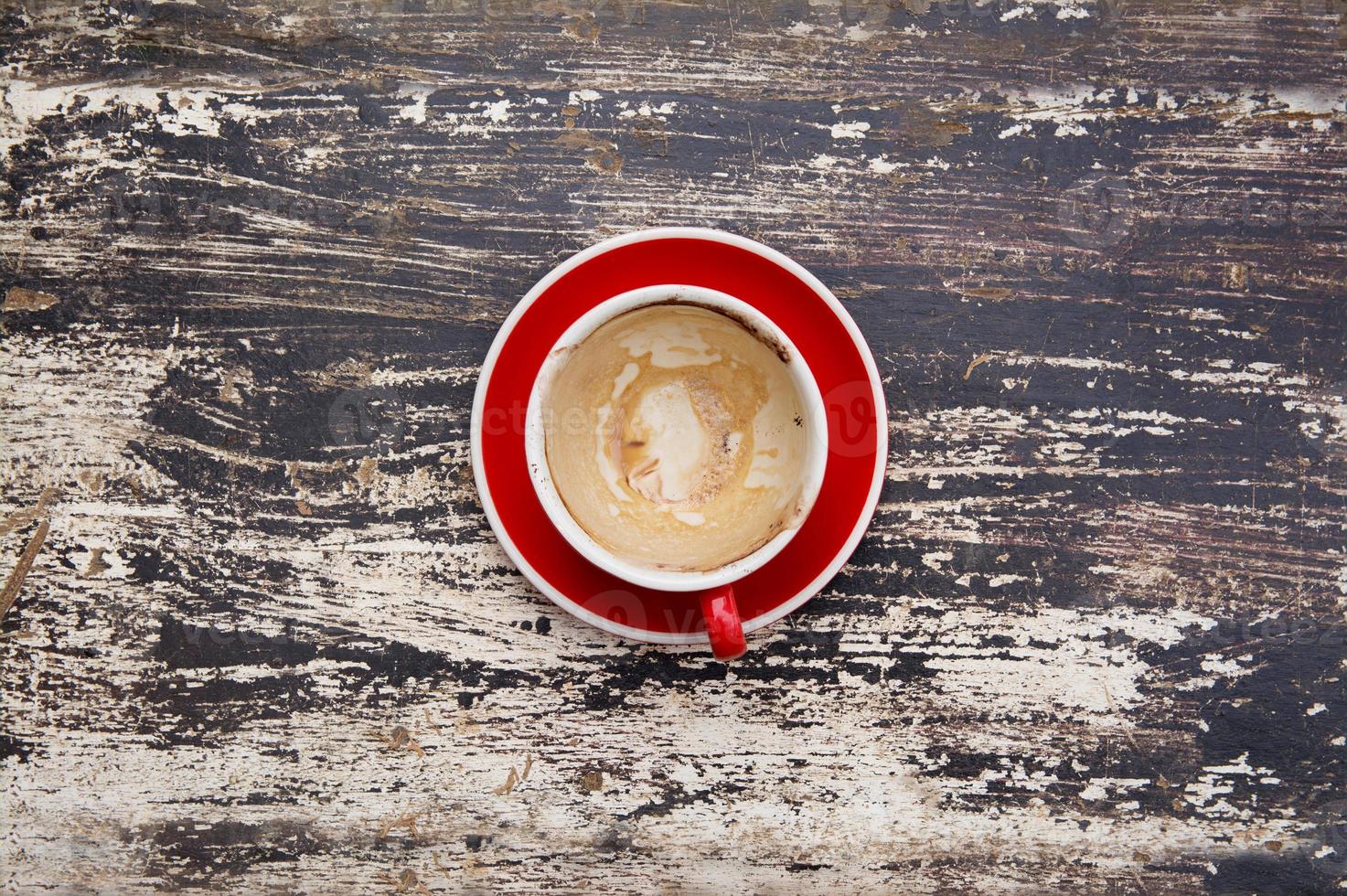 vuoto della tazza di caffè rossa usata su fondo di legno foto
