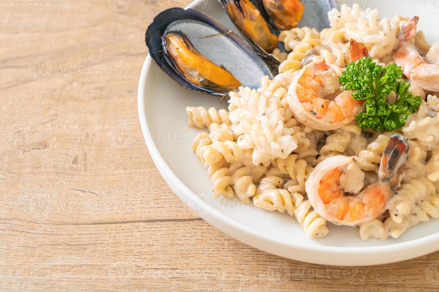 pasta a spirale crema di funghi con salsa di frutti di mare foto