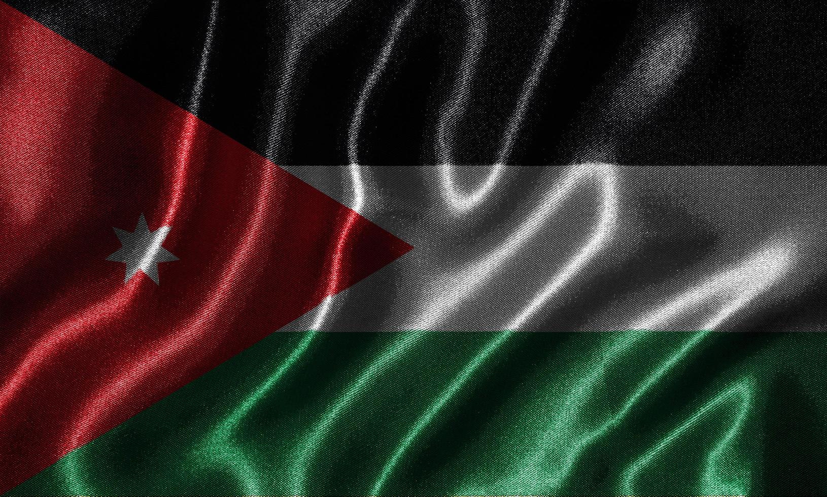 carta da parati della bandiera della giordania e sventolando la bandiera del tessuto. foto