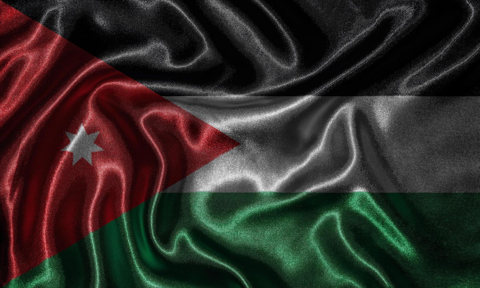 carta da parati della bandiera della giordania e sventolando la bandiera del tessuto. foto