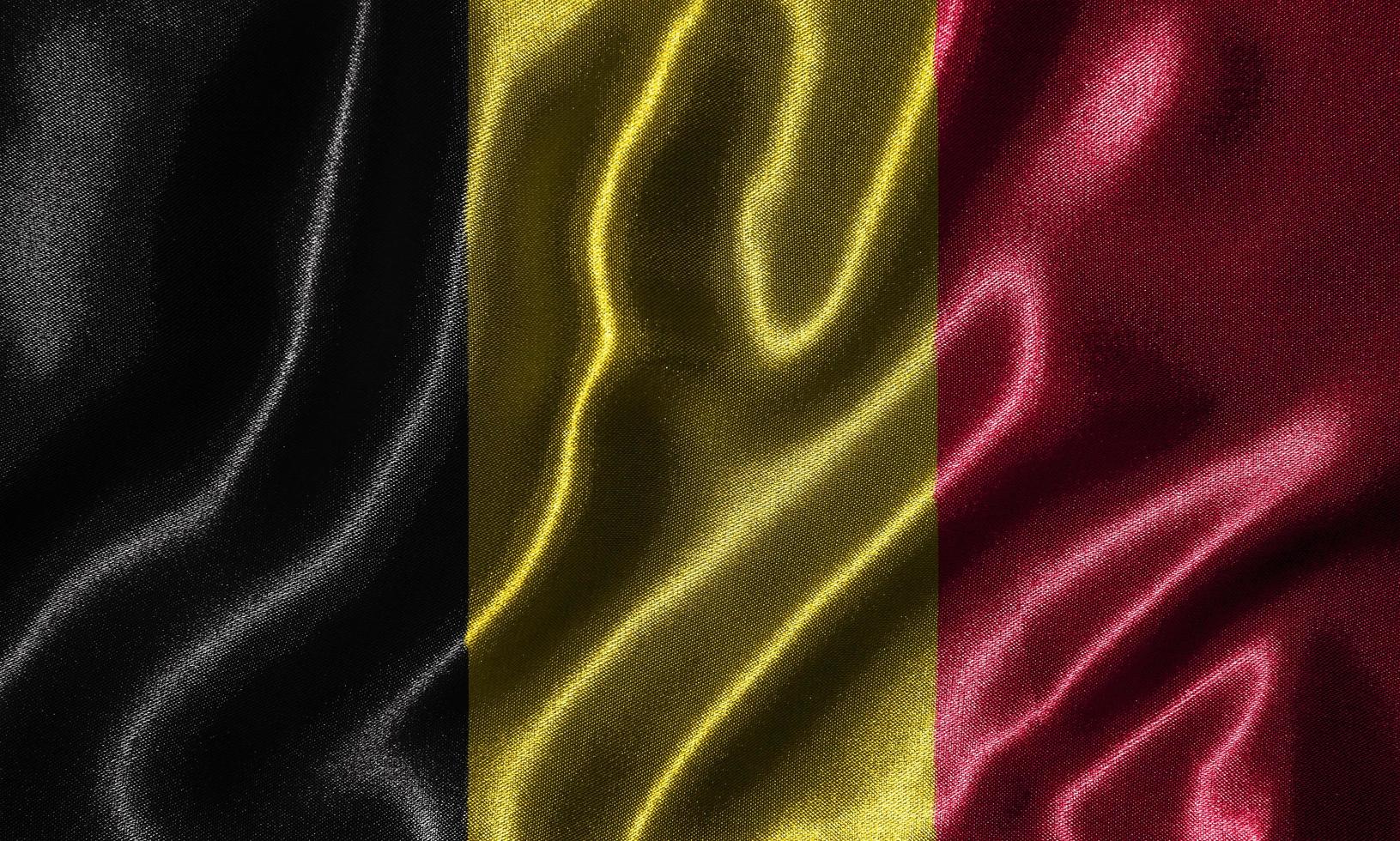 carta da parati della bandiera del Belgio e sventolando la bandiera del tessuto. foto