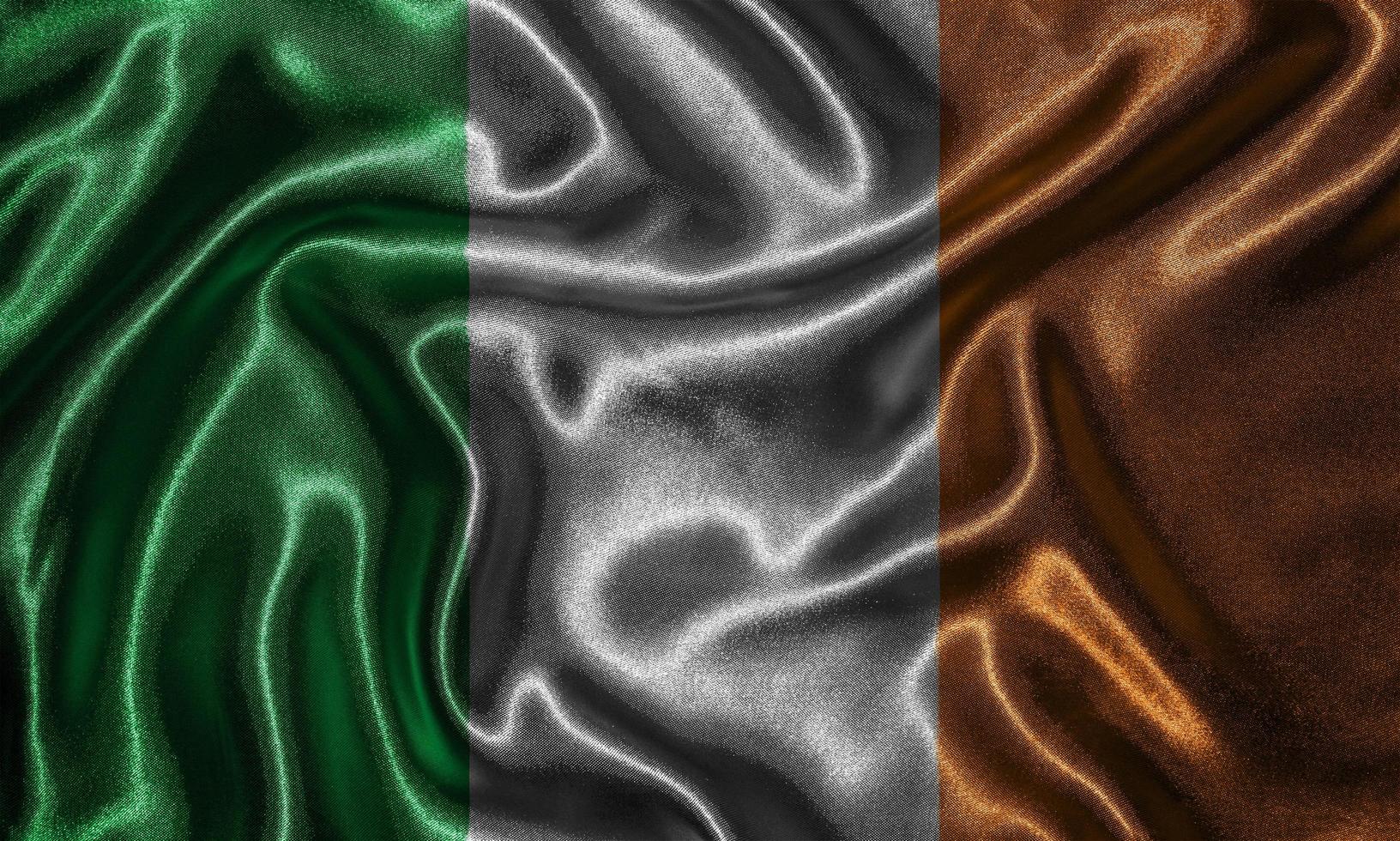carta da parati della bandiera dell'Irlanda e sventolando la bandiera del tessuto. foto