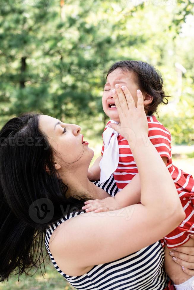 madre che calma la figlia che piange foto