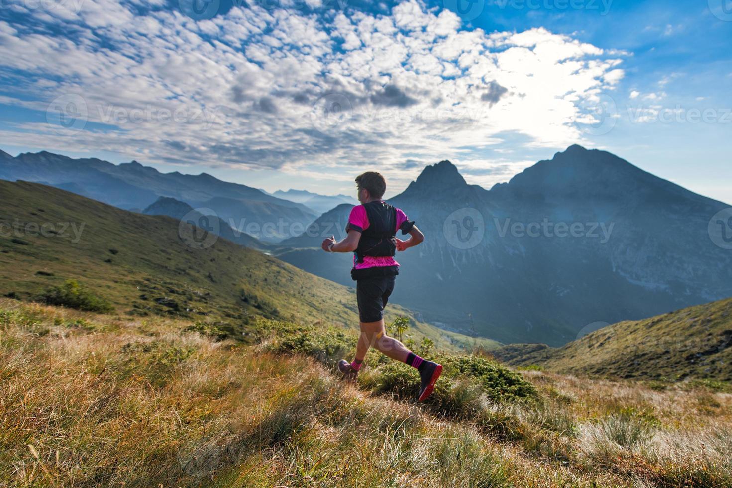 l'uomo di montagna sportivo corre in pista durante l'allenamento di resistenza foto