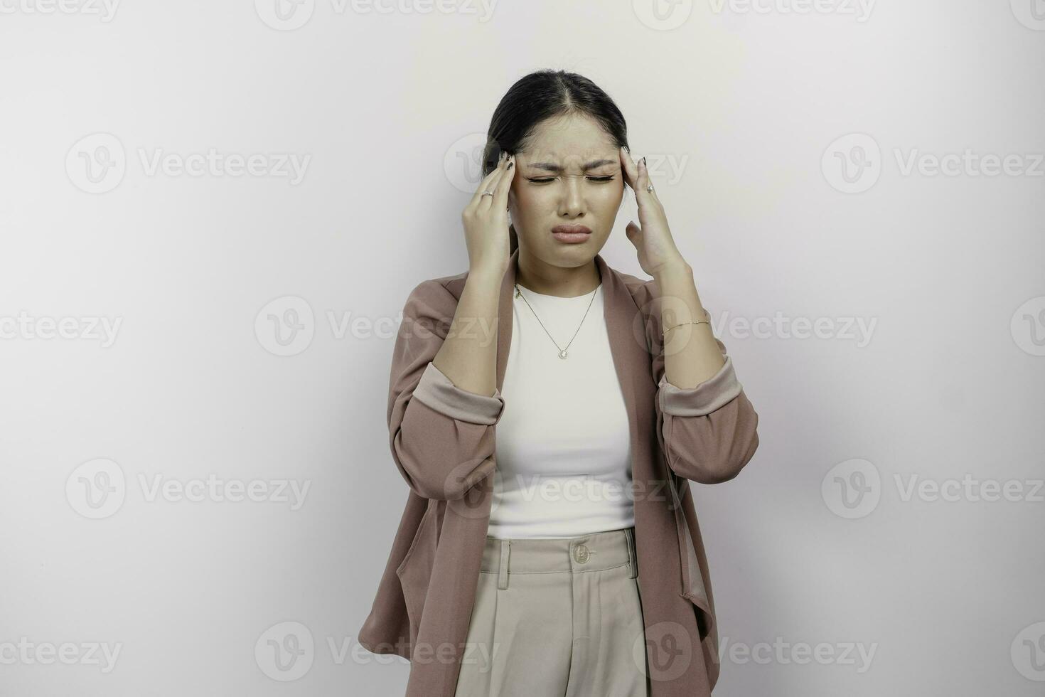 un' triste asiatico donna dipendente indossa cardigan, sembra stressato e depresso, isolato bianca sfondo. foto