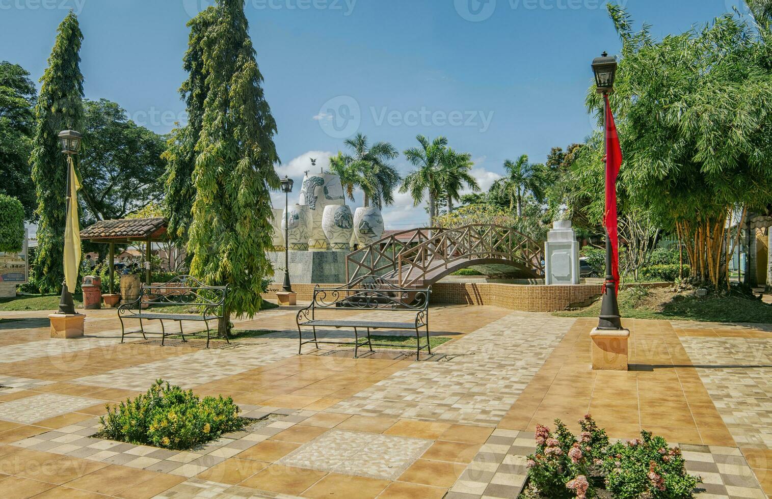 un' simpatico e rilassato parco con un' di legno ponte al di sopra di un' acqua Fontana, tradizionale parco di Nagarote, Nicaragua. Visualizza di un' calma parco con un' piccolo di legno ponte su un' soleggiato giorno. nagarote centrale parco foto