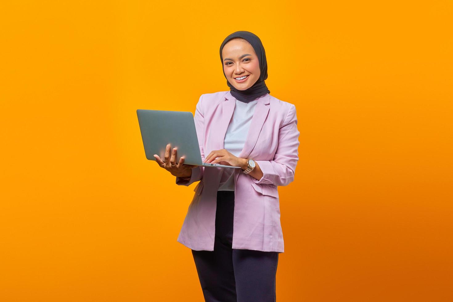 ritratto di donna asiatica sorridente che tiene laptop foto