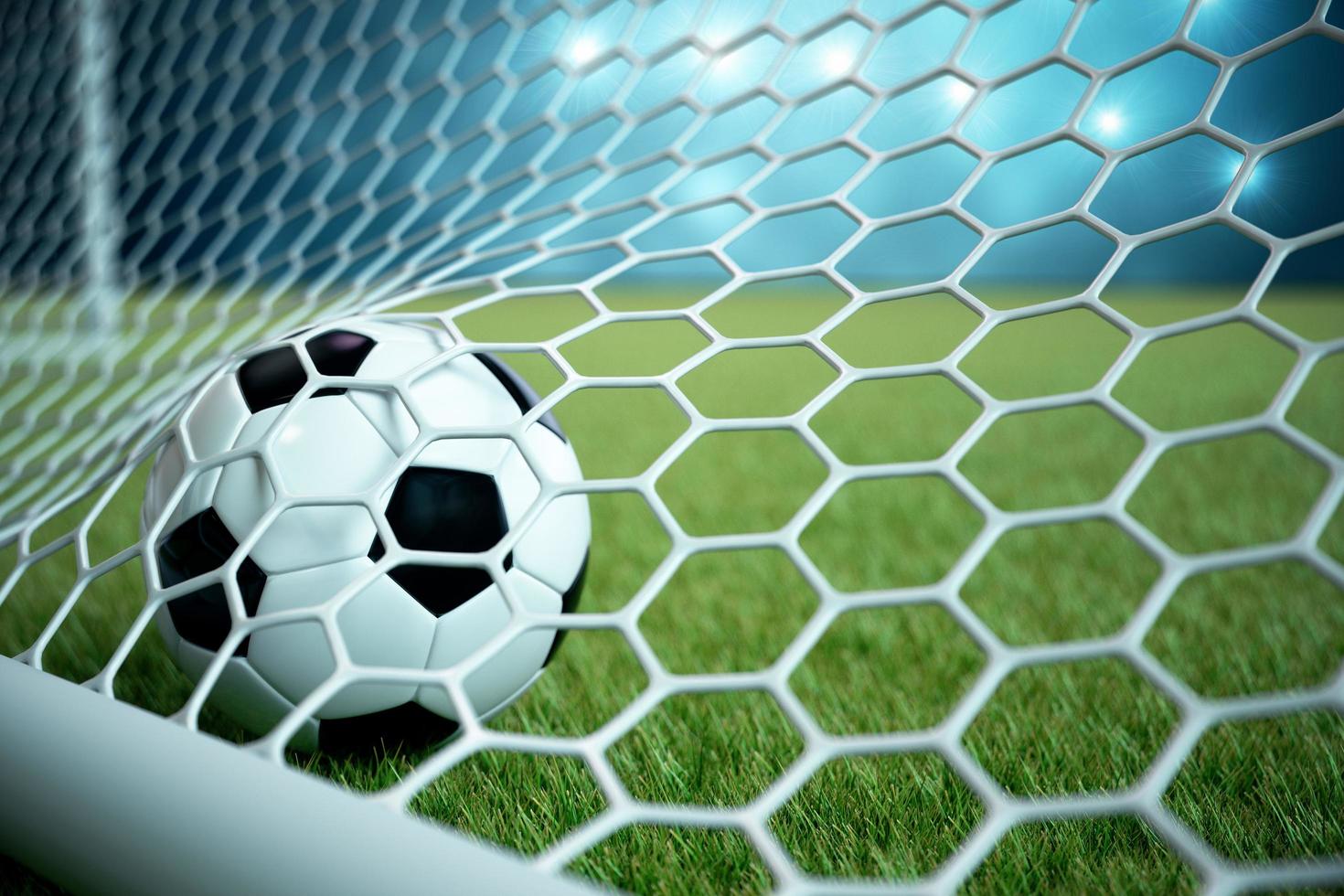 pallone da calcio in rete con riflettori e sfondo chiaro dello stadio foto