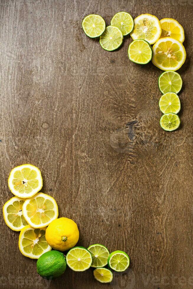 affettato Limone, lime su ardesia e di legno contatore superiore sfondo foto