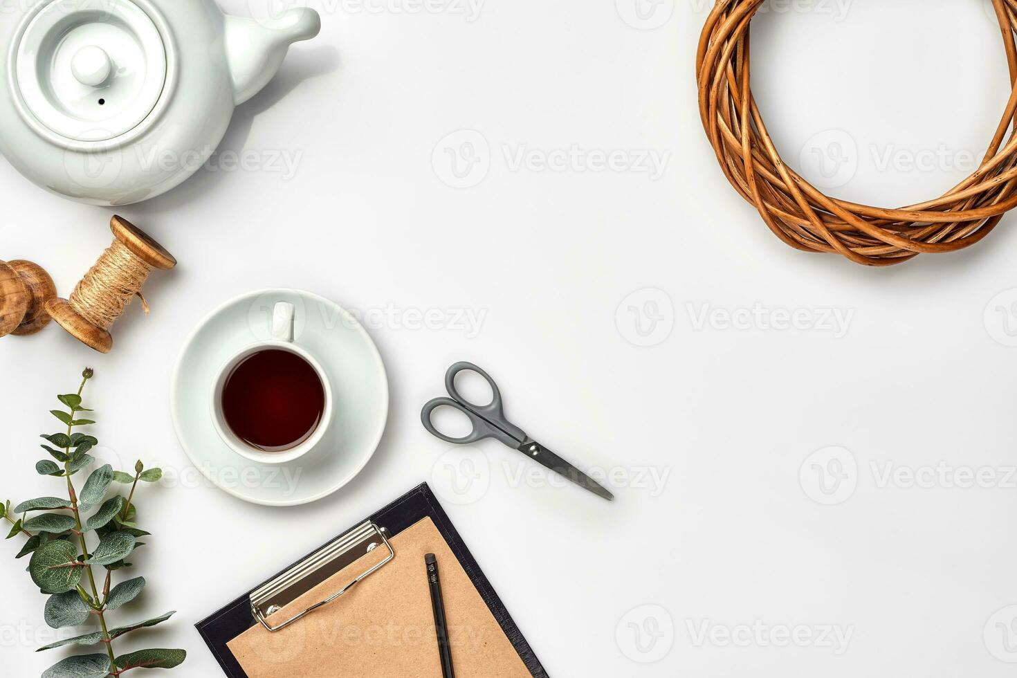 ancora vita con tè tazza e il Contenuti di un' spazio di lavoro composto. diverso oggetti su bianca tavolo. piatto posare foto