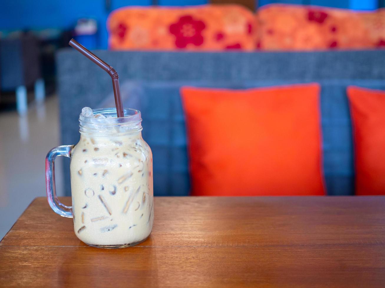 tè al latte fresco in un bicchiere posto su un pavimento di legno. con spazio libero foto