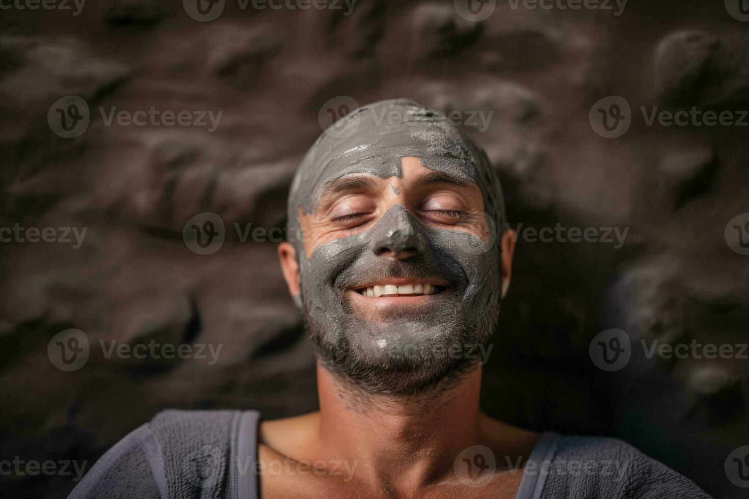 un' Calvo uomo con barba godendo un' fango facciale maschera nel un' tranquillo terme ambientazione rilassante terme sfondo con vuoto spazio per testo foto