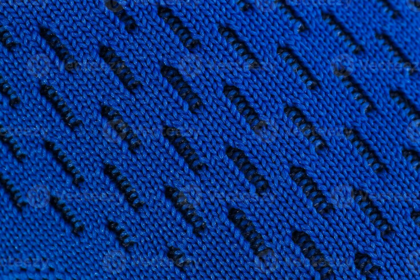 frammento di un' blu stoffa scarpa da ginnastica. il struttura di il Materiale di gli sport scarpe foto