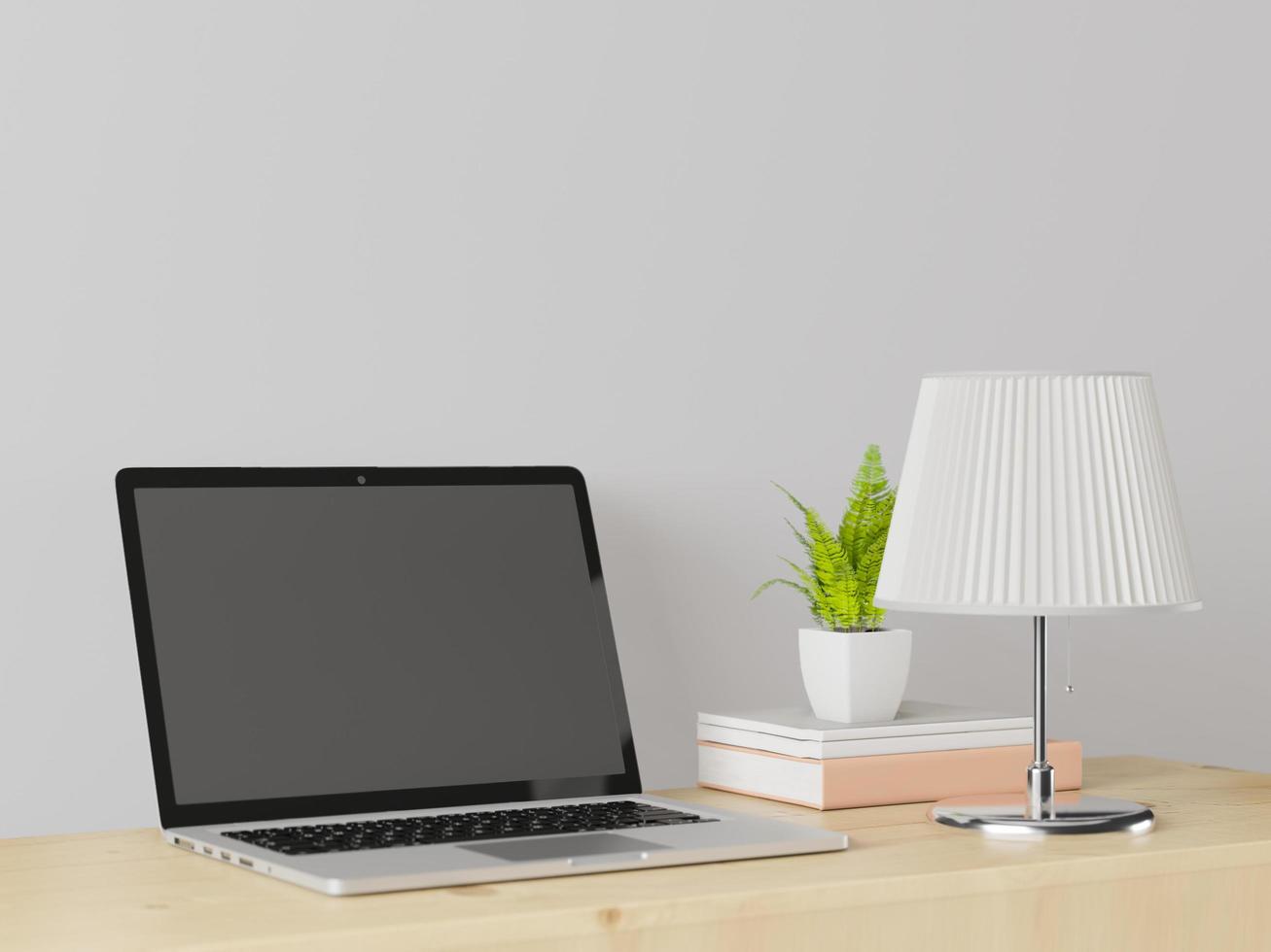 una stanza di lavoro con un laptop con una lampada posta sul tavolo. foto